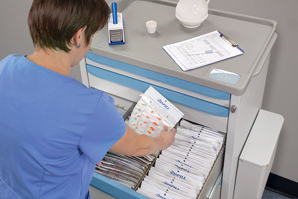 Healthcare professional using the Dispill Medication Cart