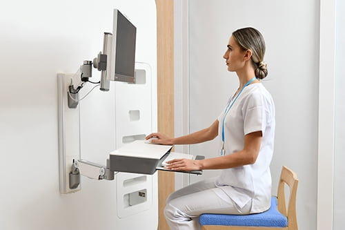 Nurse using a point of care wall workstation
